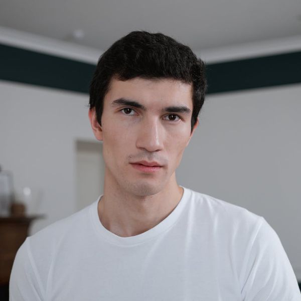 Woman with a calm and focused expression looking forward.